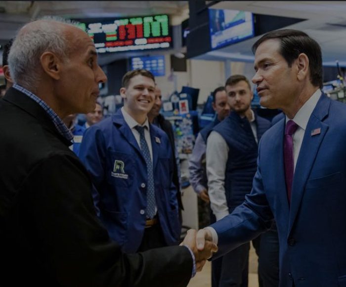 Secretary of State Marco Rubio shakes hands with Roberts and Ryan employees on the NYSE floor.